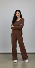 Woman wearing a brown outfit standing against a plain background