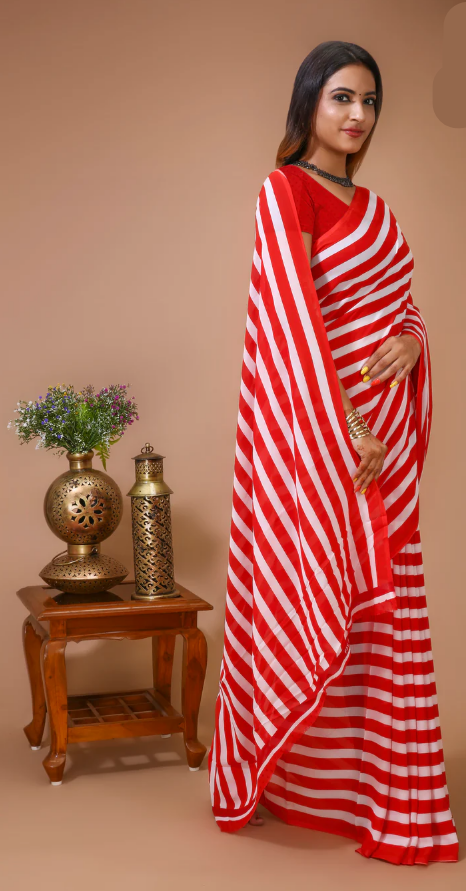 Woman wearing a red and white striped saree with a minimal background