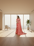 Woman wearing a red and white striped saree on a white background