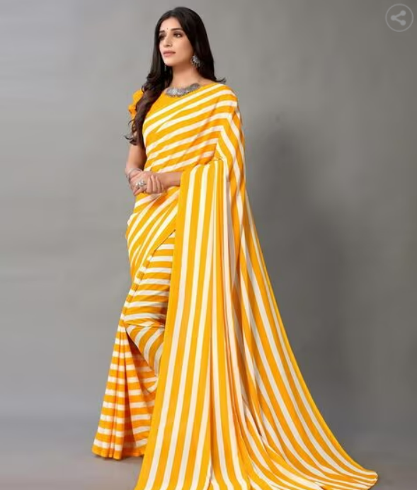 Woman wearing a yellow and white striped dress holding flowers indoors.