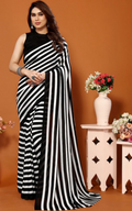 Woman wearing a black and white striped saree against an orange background