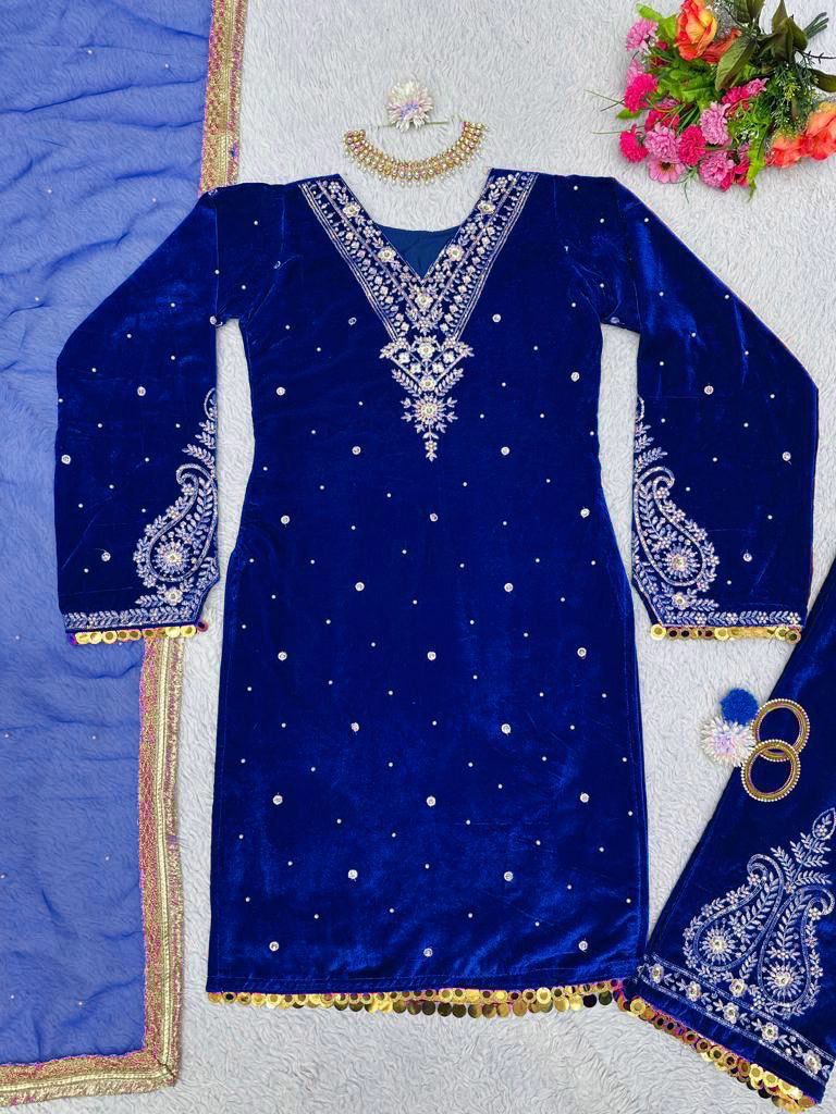 Woman wearing a blue traditional outfit with a matching dupatta indoors.