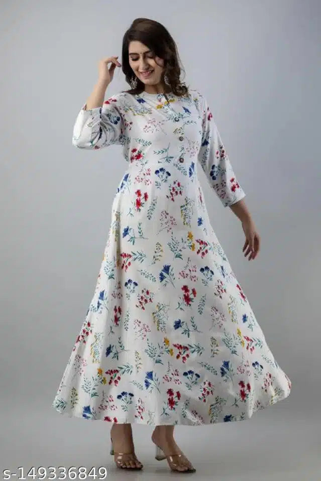 Woman wearing a floral dress against a plain background