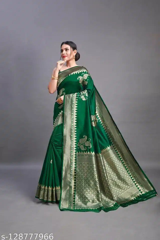Woman wearing a green saree with a gray background