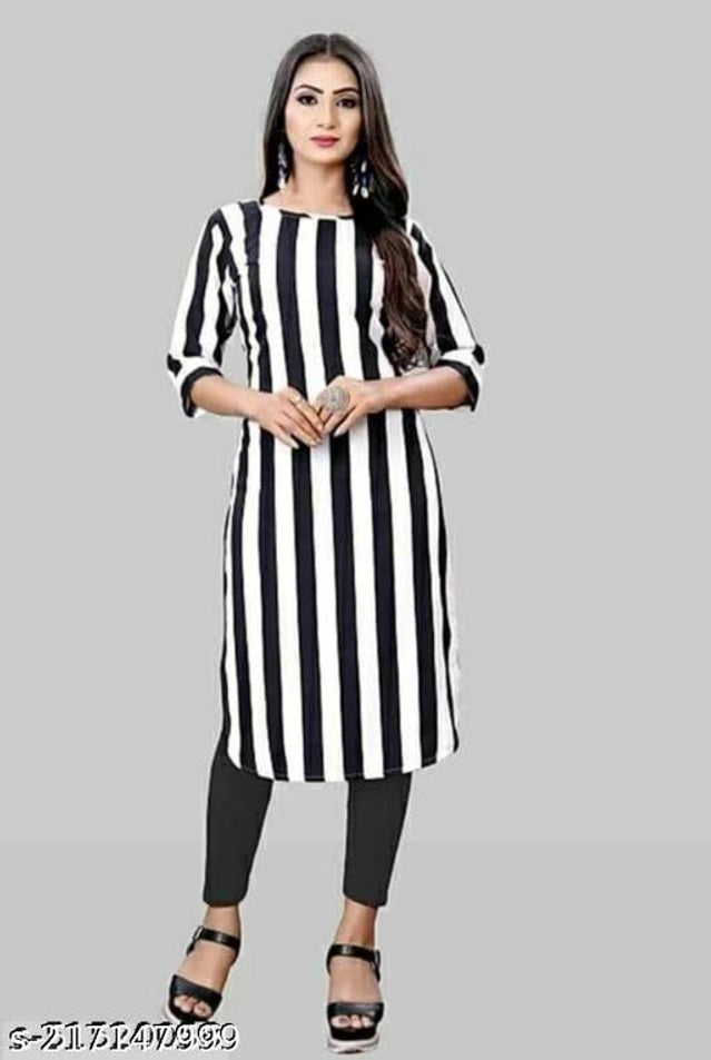 Woman wearing a black and white striped kurta on a gray background