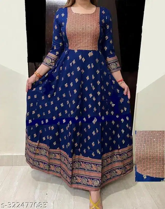 Woman wearing a blue and pink traditional outfit with intricate patterns.