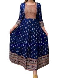 Woman wearing a blue and pink traditional outfit with intricate patterns.