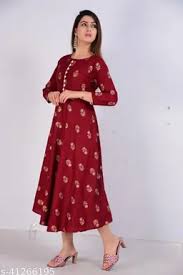 Woman wearing a red dress with gold patterns on a white background