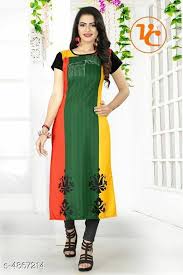 Woman wearing a colorful dress with a brand logo in the corner